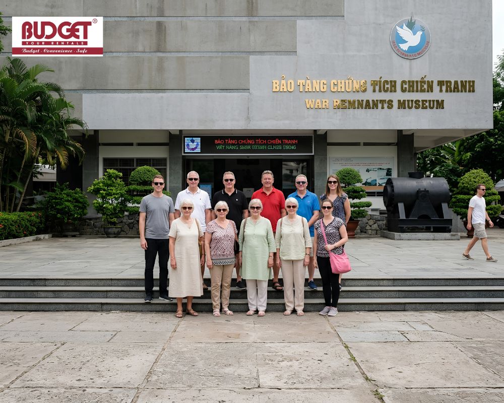 A-group-of-European-tourists-posing-in-front-of-the-War-Remnants-Museum