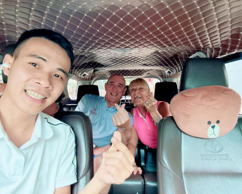 Our driver takes a photo with tourist in our car in Dalat