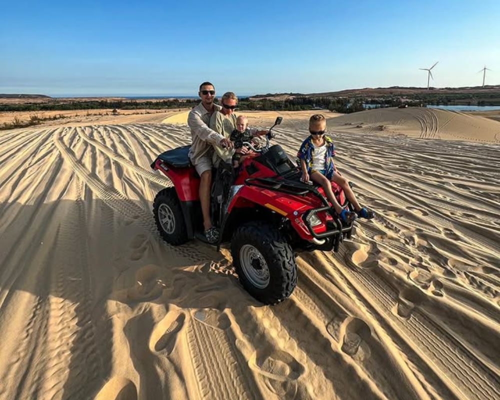 The family enjoy ATV car in Muine sand dune