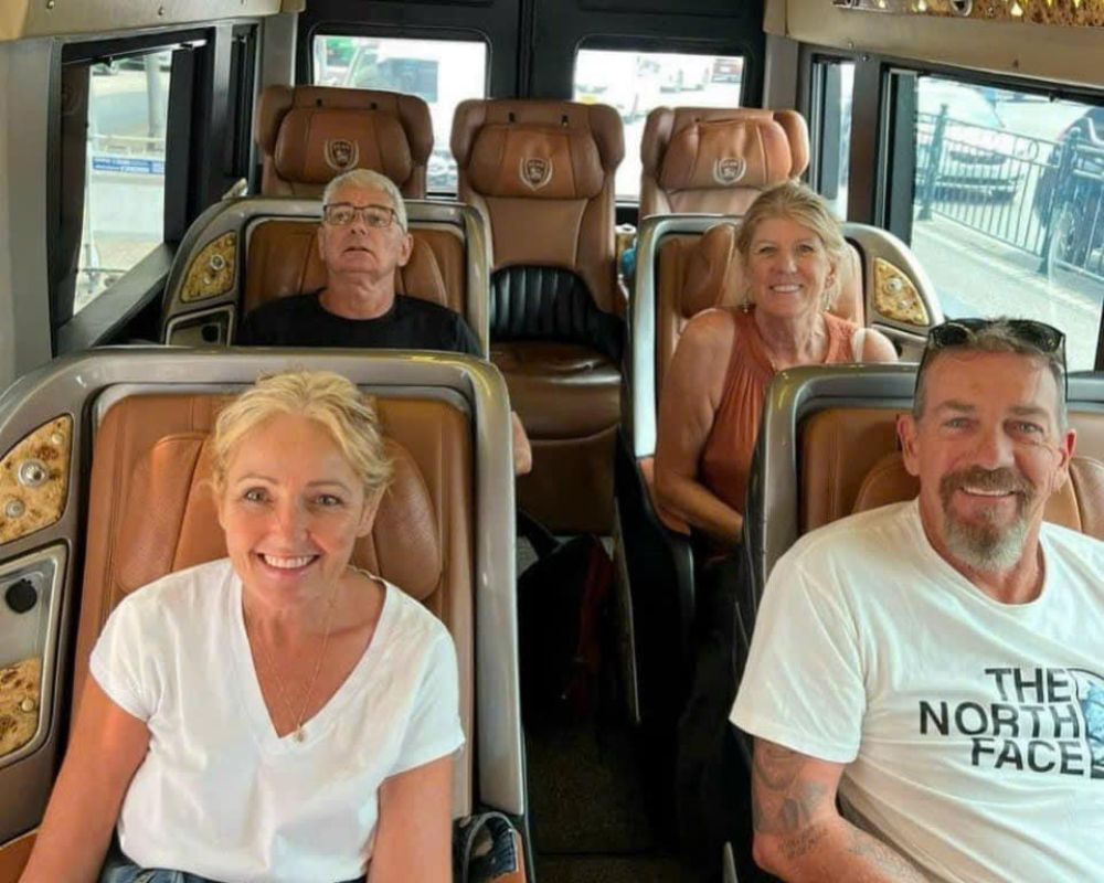 Tourists relax in comfortable leather seats inside a stylish