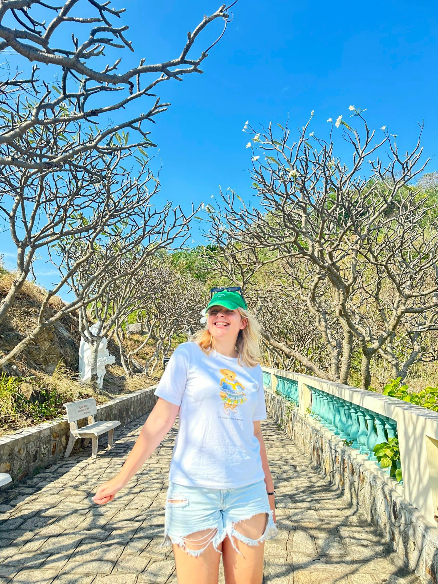 Woman walking along a stone path at Thich Ca Phat Dai pagoda Vung Tau