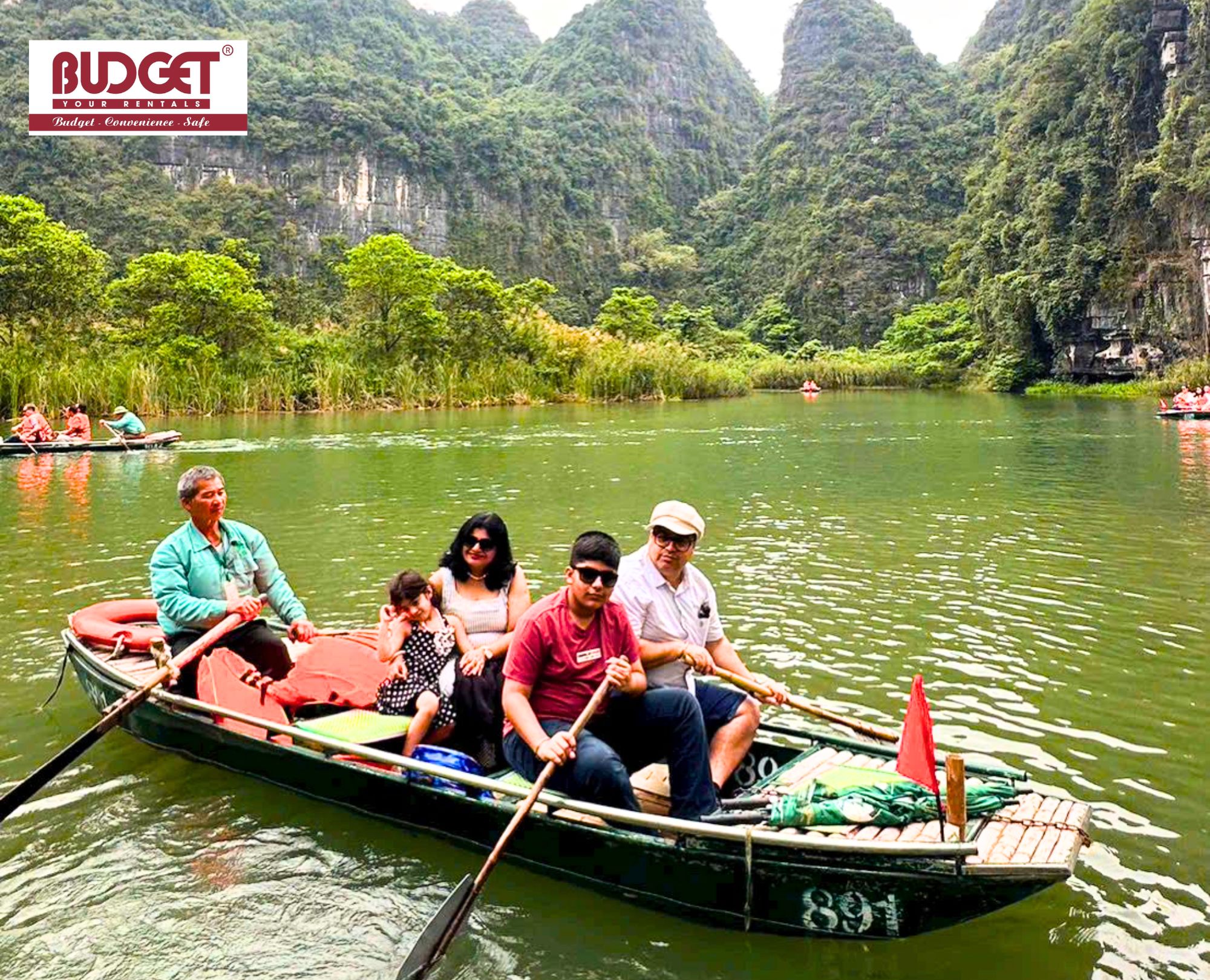 Happy-family-on-a-traditional-sampan-boat-ride-in-Trang-An-eco-tourism-complex