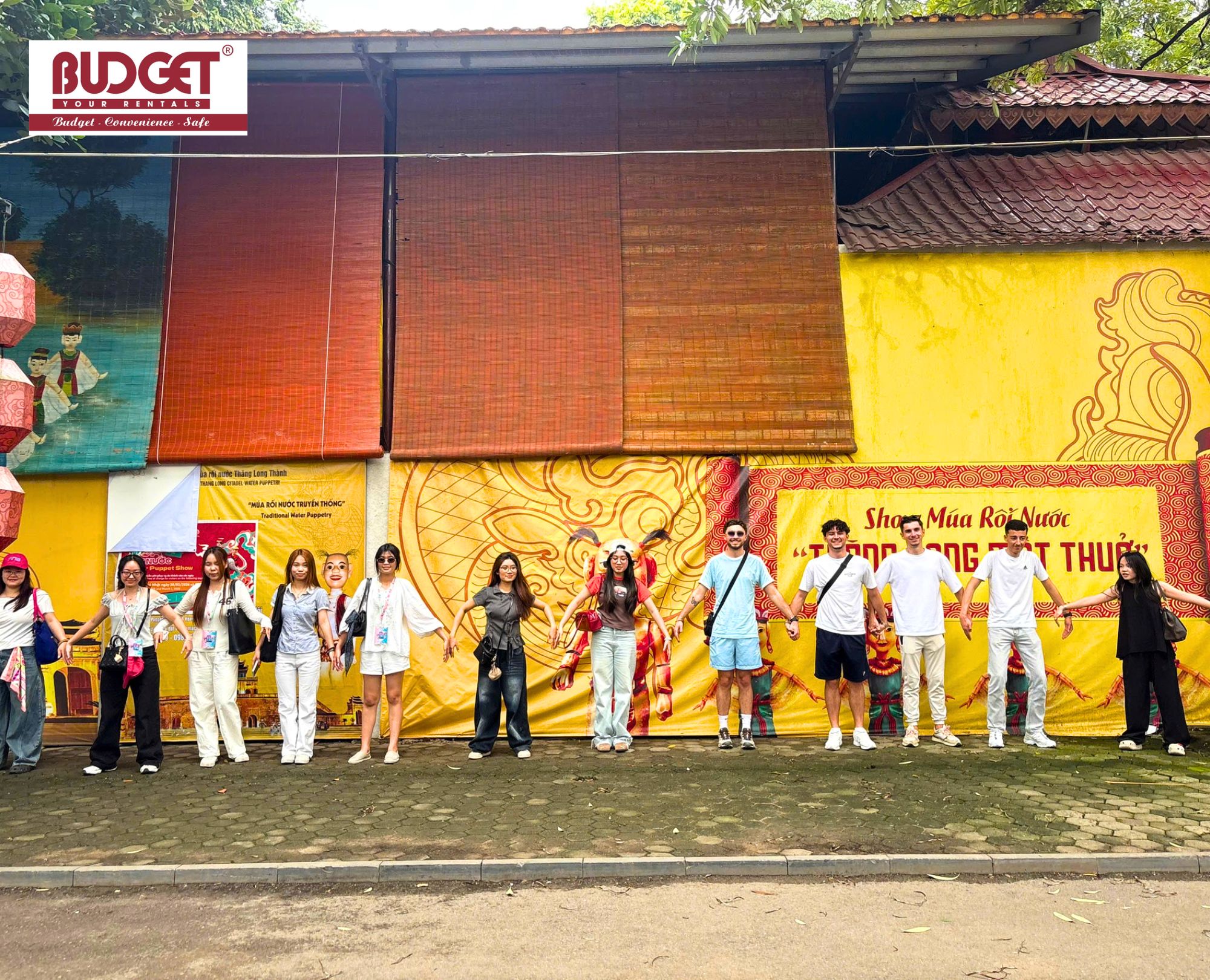 International-tour-group-enjoying-a-Hanoi-sightseeing-trip-to-a-traditional-Water-Puppet-show-theater