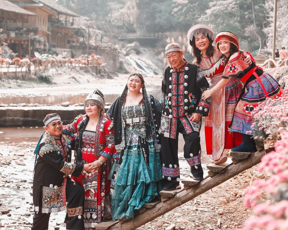 Tourists wearing national costumes at Cat Cat village