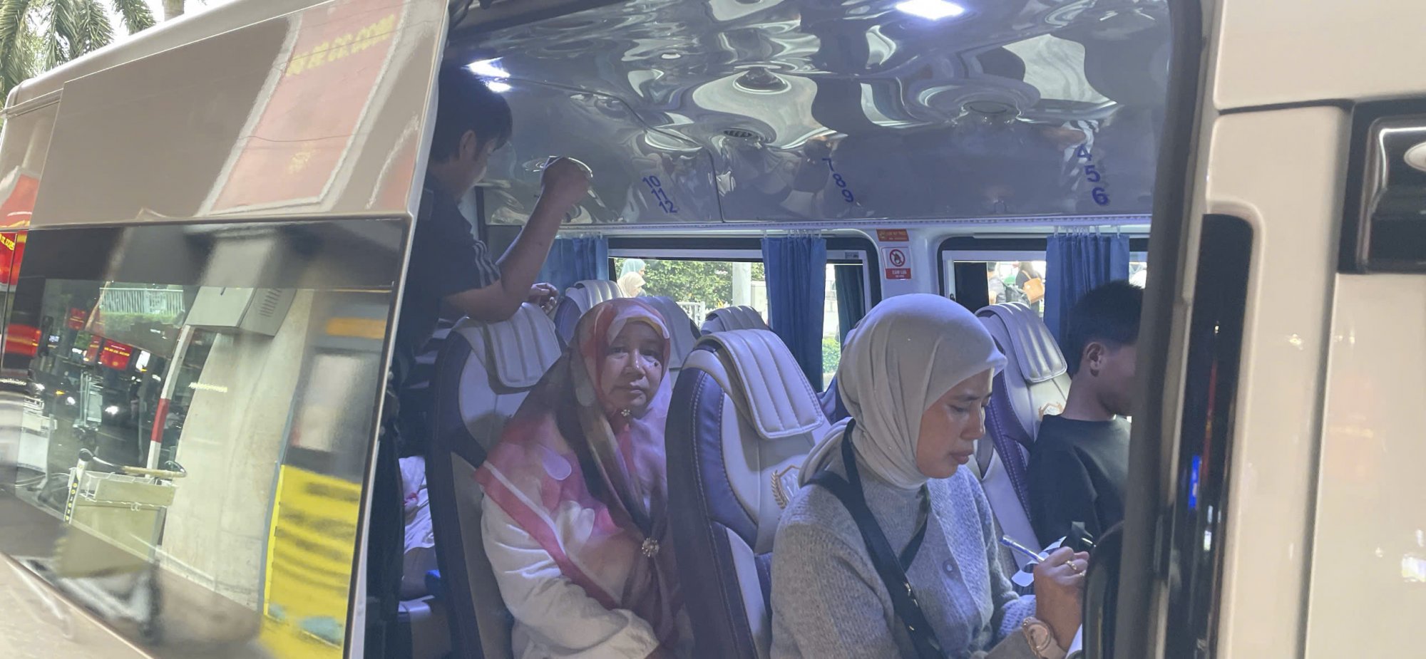 International-tourists-sitting-comfortably-inside-a-spacious-airport-transfer-van