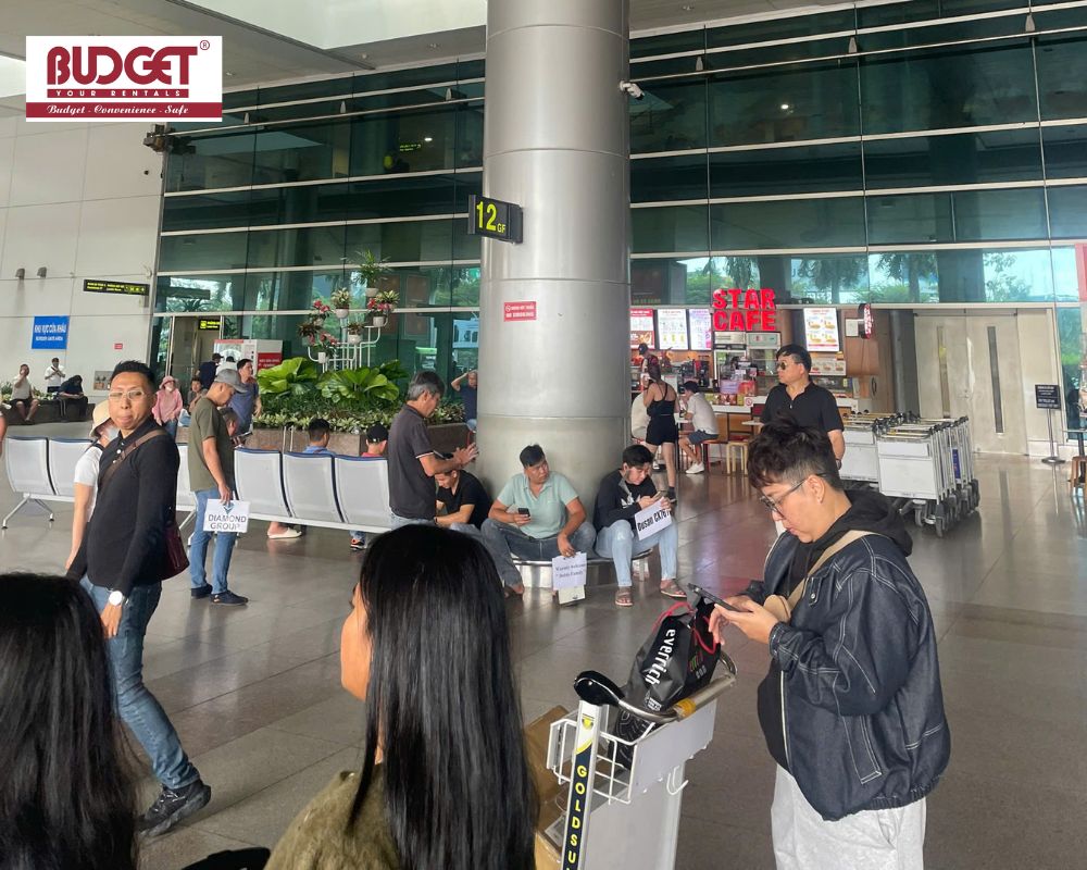 Drivers-holding-welcome-name-boards-waiting-to-pick-up-arriving-passengers-at-Tan-Son-Nhat-Airport-terminal