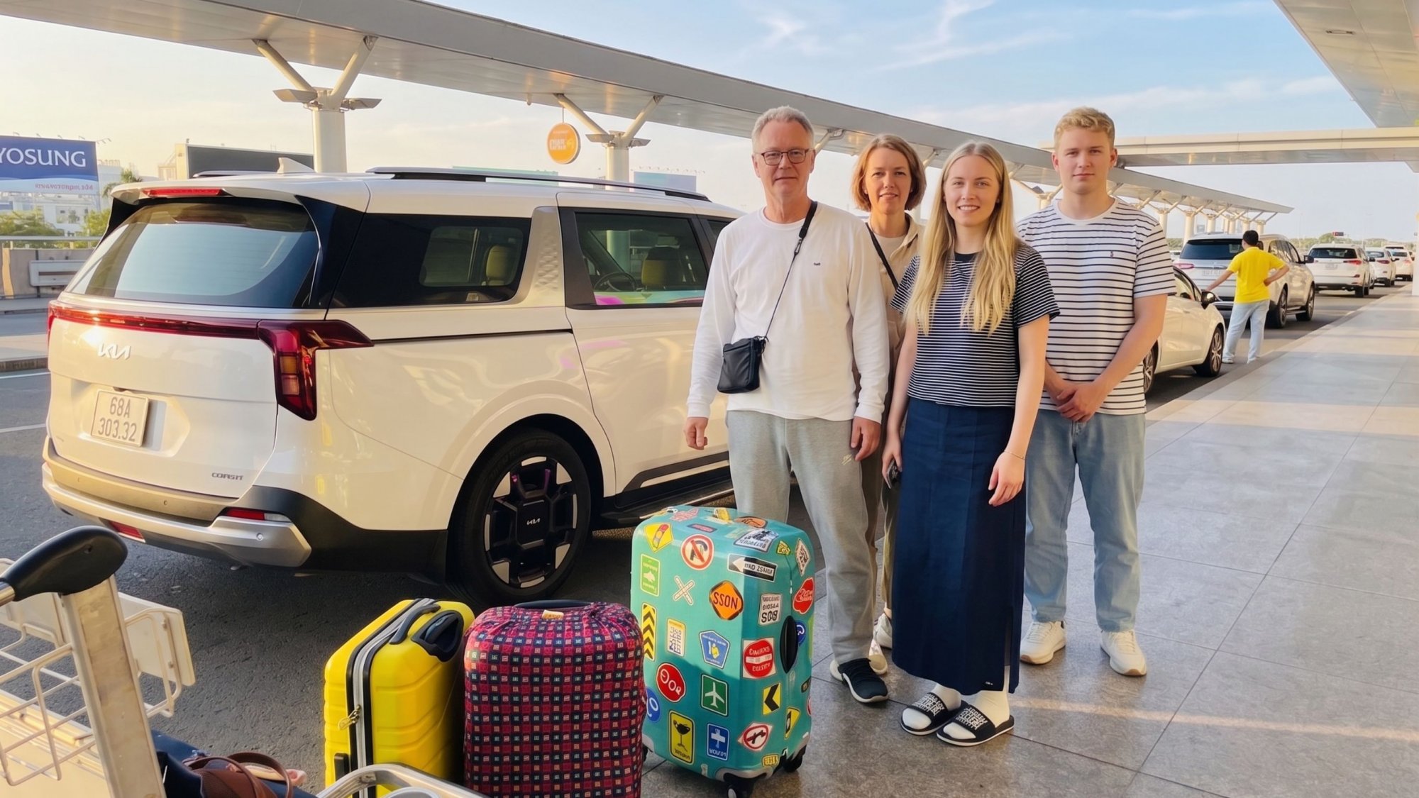 Family-of-four-waiting-at-the-airport-terminal-with-their-suitcases-for-our-premium-7-seater-private-car-pickup