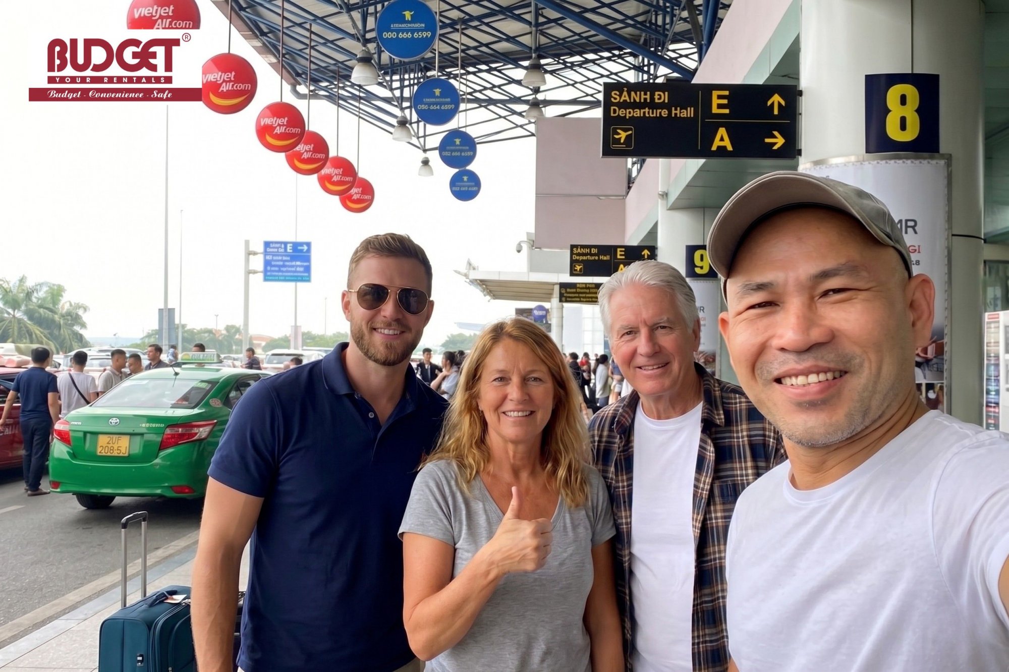 Foreign-tourists-taking-a-group-selfie-with-our-driver-at-Noi-Bai-International-Airport-Departure-Hall