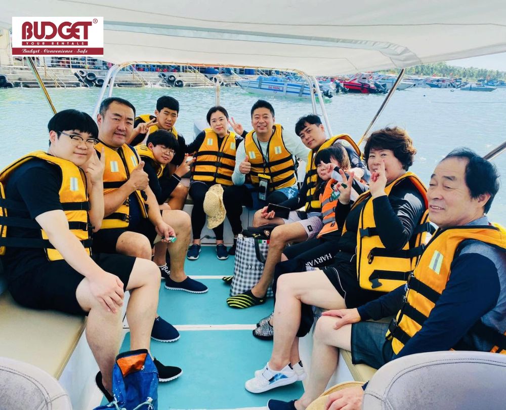 Group-of-happy-Asian-tourists-wearing-yellow-life-jackets-taking-a-photo-on-a-boat-tour-in-Nha-Trang-Bay