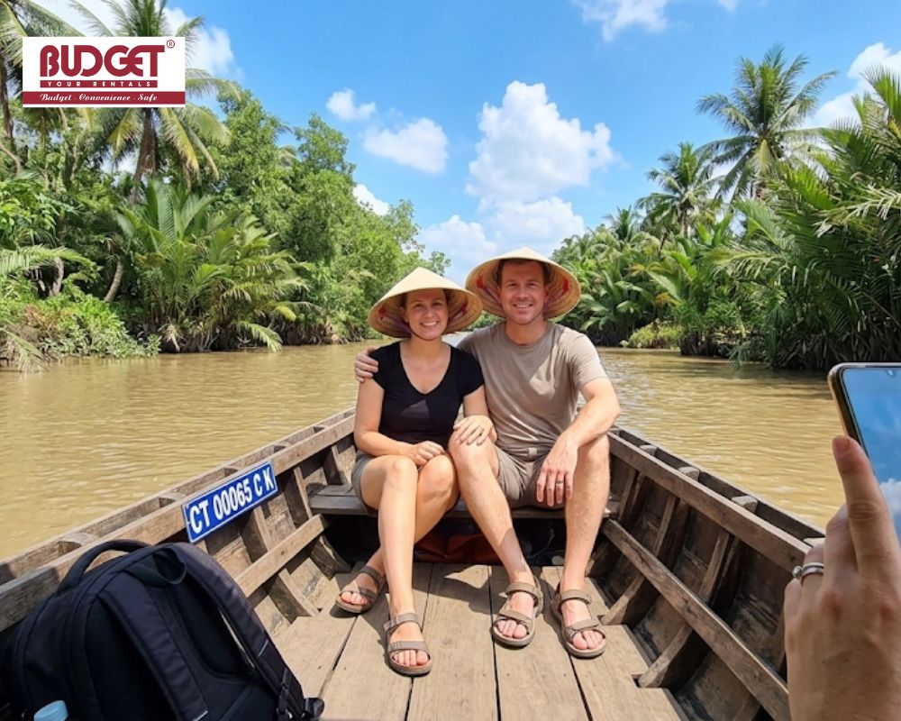 Happy-couple-wearing-traditional-conical-hats-posing-for-a-photo-on-a-wooden-boat