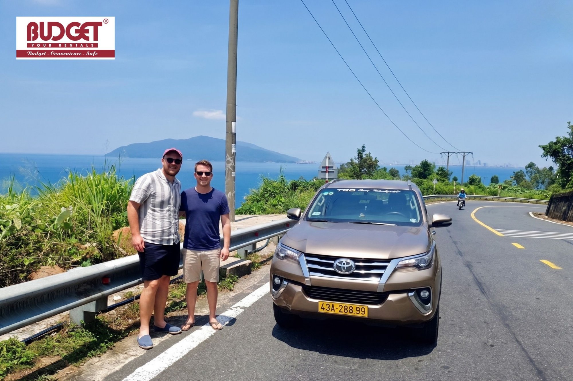 Happy-travelers-posing-next-to-our-private-transfer-SUV-during-their-journey-from-Da-Nang-to-Hue