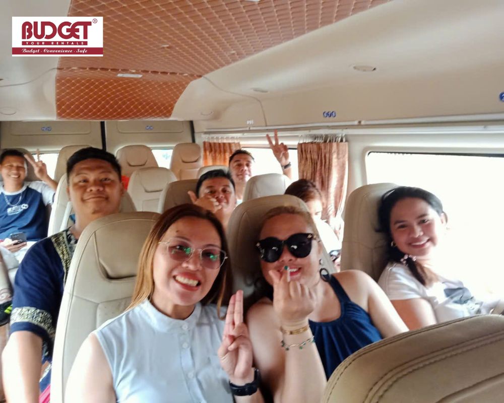 Joyful-passengers-taking-a-group-selfie-inside-a-comfortable-16-seater-minibus