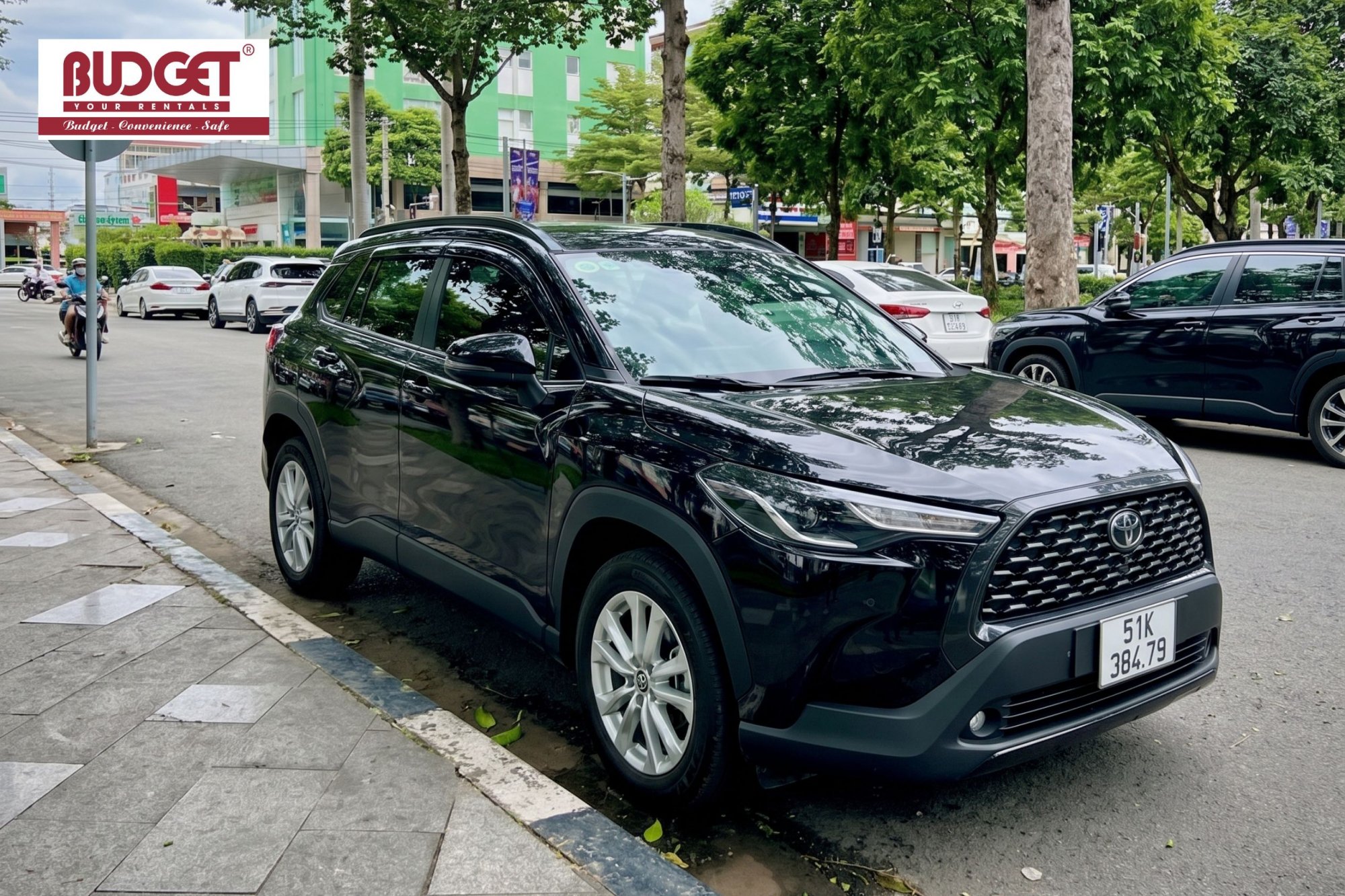 Our-black-Toyota-Corolla-Cross-private-transfer-car-parked-on-a-street-in-Ho-Chi-Minh-City
