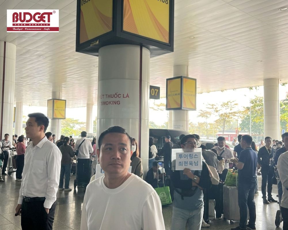 Our-driver-holding-a-welcome-sign-for-a-Korean-tourist-at-Noi-Bai-airport-arrival-terminal