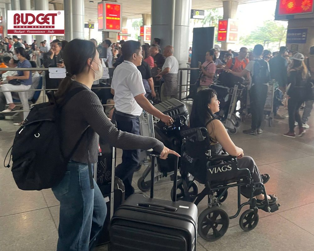 Our-driver-providing-wheelchair-assistance-to-a-passenger-navigating-through-a-crowded-arrival-terminal