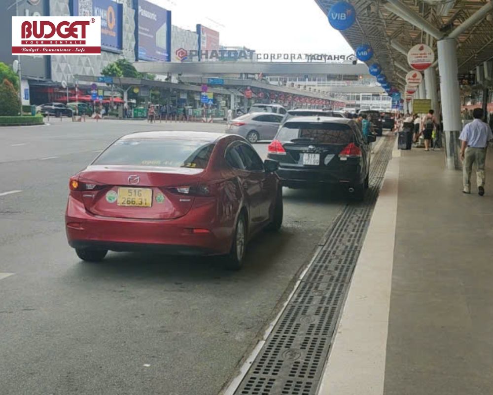 Our-red-4-seater-Mazda-3-private-car-waiting-to-pick-up-passengers-at-the-Ho-Chi-Minh-City-airport-arrival-lane