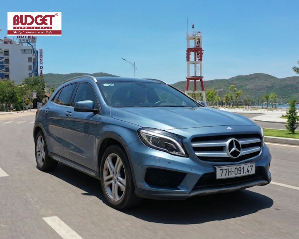 Premium-blue-Mercedes-SUV-driving-along-a-scenic-coastal-road-during-a-private-car-transfer-from-Quy-Nhon-to-Nha-Trang