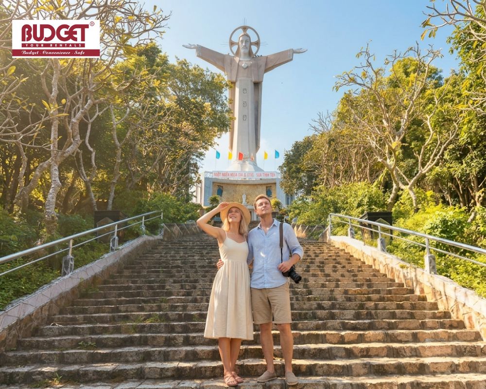 The-couple-posing-on-the-stone-steps-leading-up-to-the-giant-Christ-the-King-statue