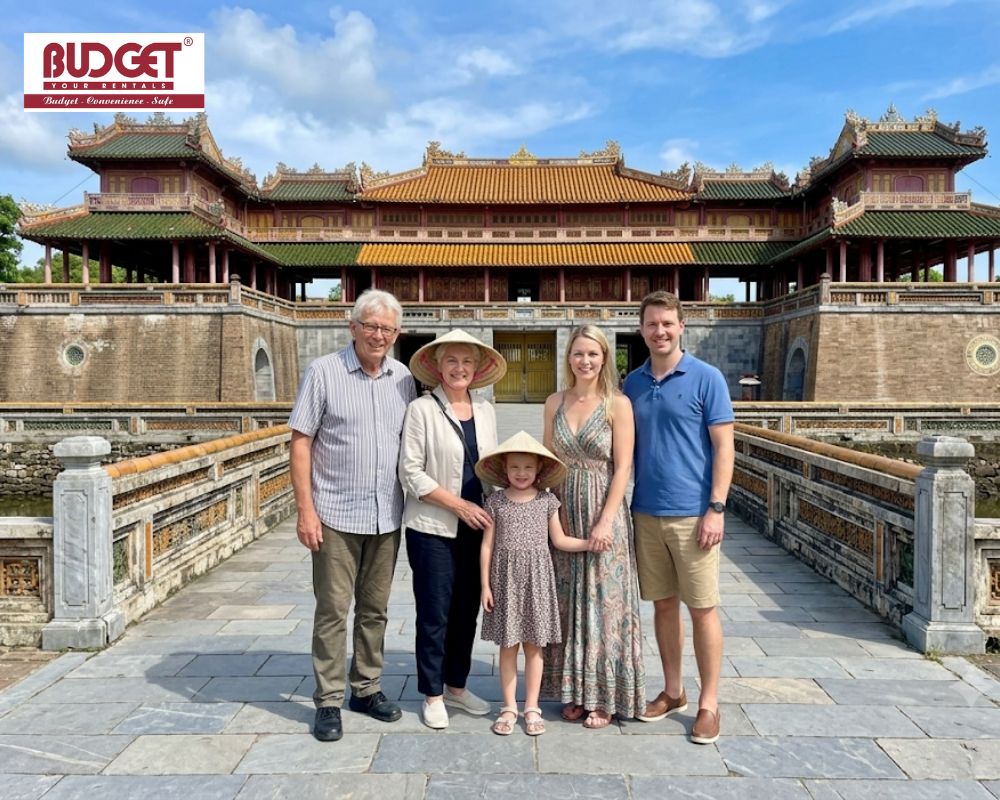 A-British-family-wearing-traditional-conical-hats-posing-in-front-of-Hue-Imperial-Citadel