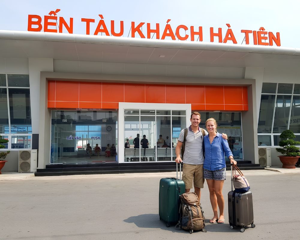 A-couple-posing-with-their-luggage-at-the-Ha-Tien-Ferry-Terminal