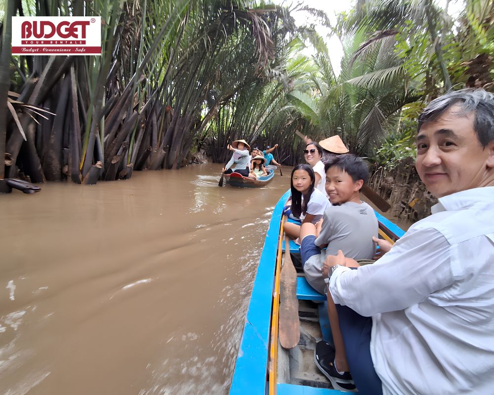 A-family-enjoying-a-traditional-sampan-boat-tour-through-the-coconut-palm-groves-in-Ben-Tre