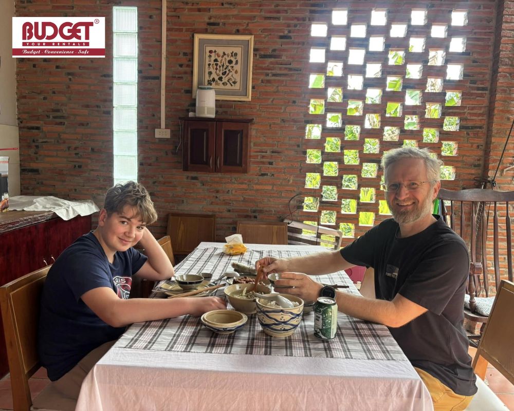 A-father-and-son-enjoying-a-delicious-lunch-at-a-local-restaurant-in-Mekong-Delta
