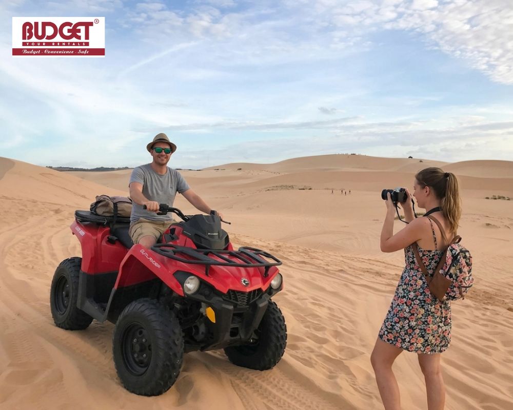 A-female-traveler-photographed-her-husband-riding-a-red-ATV-quad-bike-at-White-Sand-Dunes