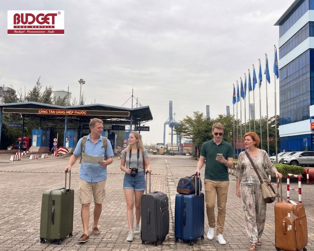 A-group-of-tourists-walking-with-their-luggage-at-the-entrance-of-Tan-Cang-Hiep-Phuoc-Port