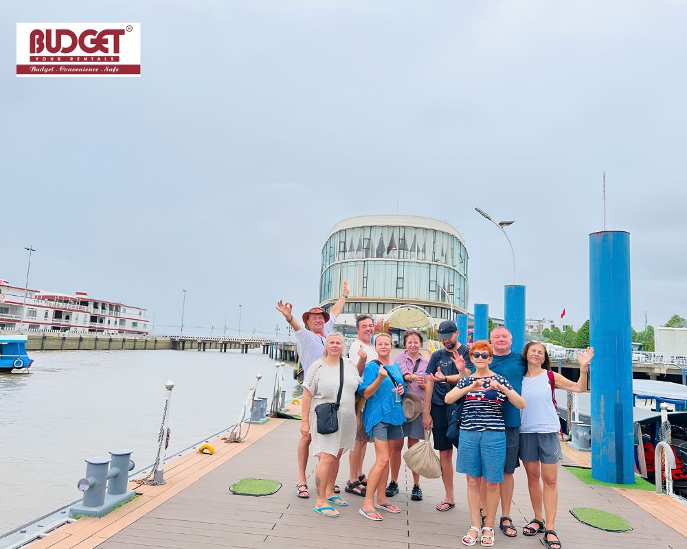 A-happy-group-of-international-travelers-posing-at-the-pier-in-My-Tho