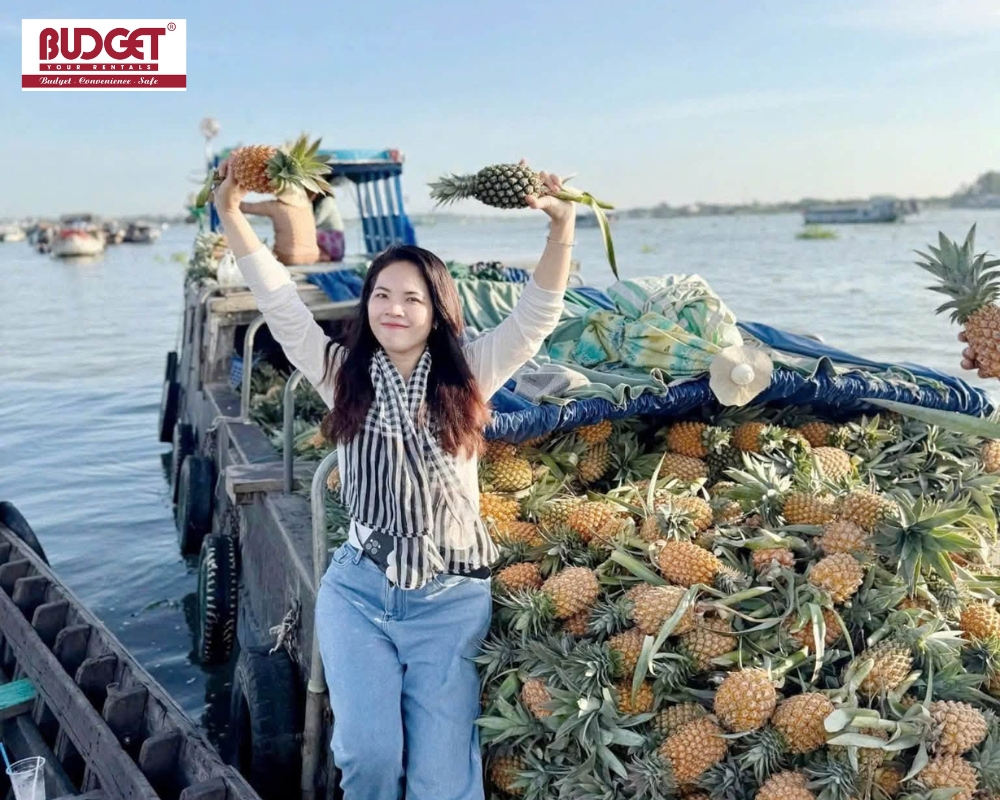 A woman poses for a memorable photo while visiting Long Xuyen Floating Market