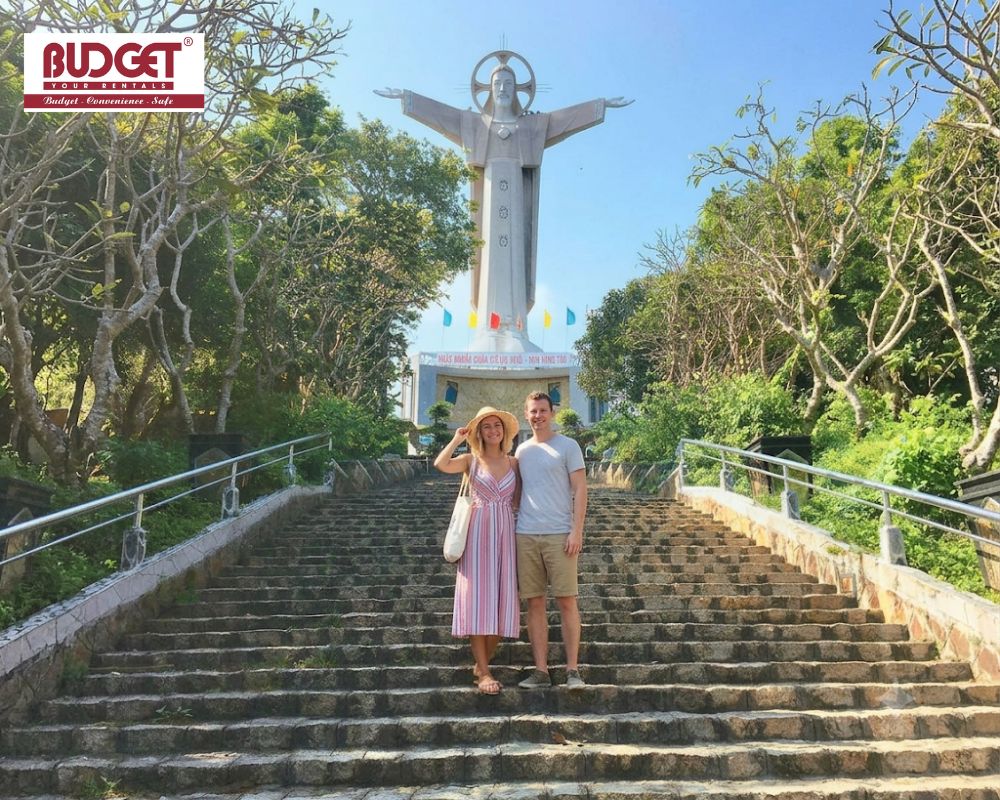 An-American-couple-posing-on-the-steps-of-Christ-the-King-statue-in-Vung-Tau