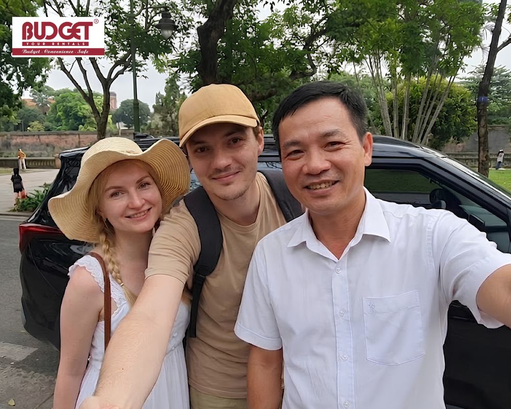 British-tourist-couple-taking-a-selfie-with-our-local-private-car-driver-during-a-sightseeing-city-tour-in-Da-Nang