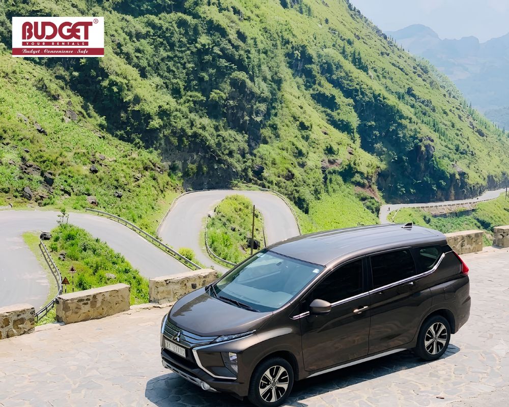 Brown-Mitsubishi-Xpander-parked-at-a-scenic-viewpoint-overlooking-the-spectacular-winding-mountain-roads-of-Tham-Ma-Pass