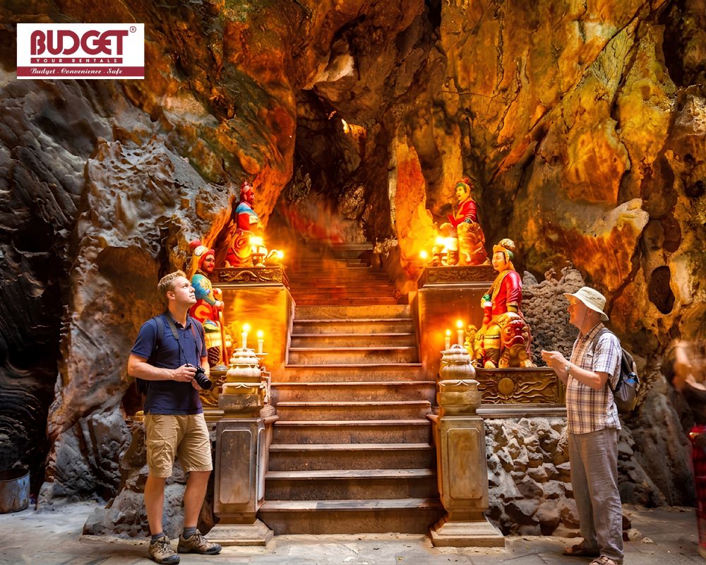 Canadians-tourists-exploring-the-magnificent-illuminated-cave-temples-and-ancient-stone-shrines-inside-Marble-Mountains