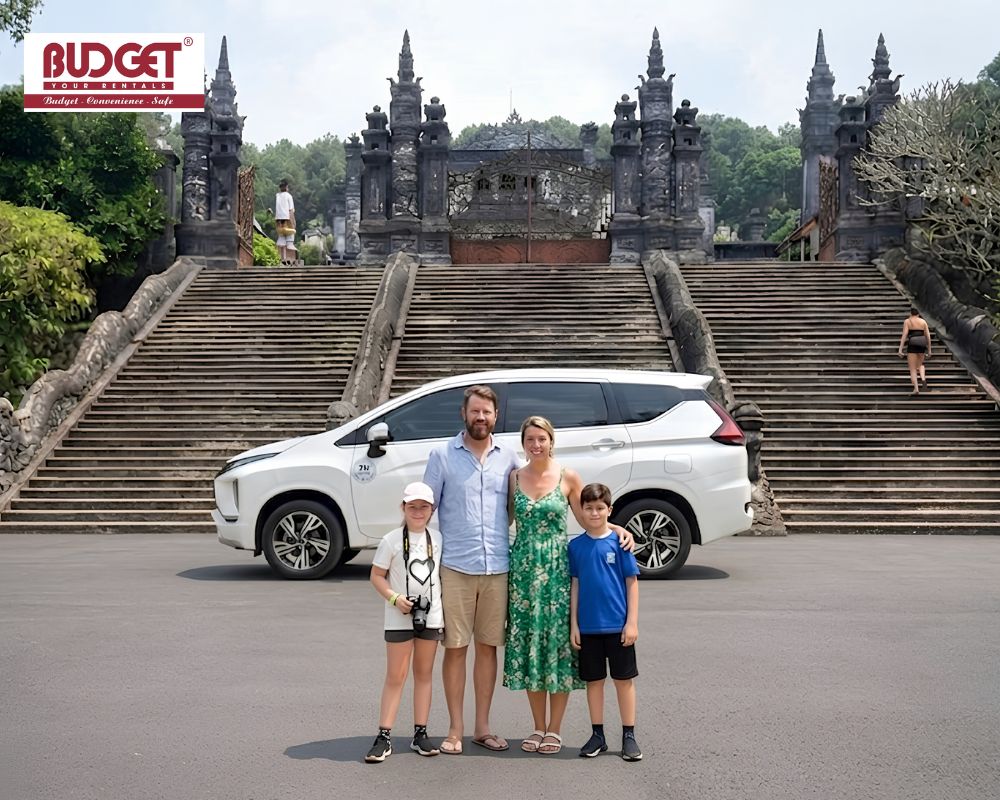 Foreign-family-posing-with-a-white-Mitsubishi-MPV-at-the-historic-Khai-Dinh-Tomb-in-Hue