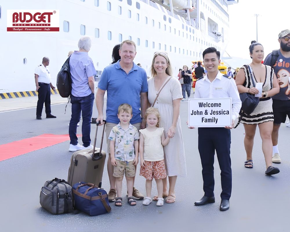 Our-driver-and-American-family-took-a-picture-with-a-welcome-sign-at-Cam-Ranh-Port