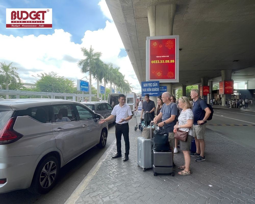 Our-driver-welcomed-international-travelers-and-showed-them-to-our-car-at-the-airport-arrival-terminal