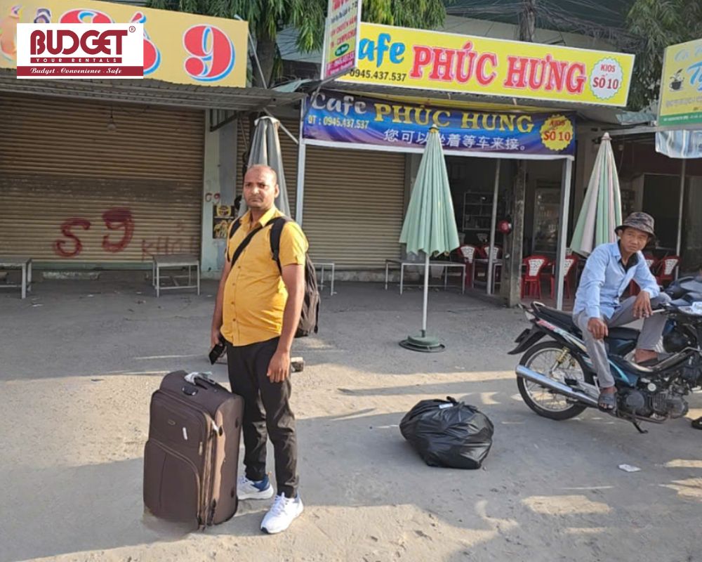 Our-international-traveler-standing-with-his-luggage-outside-local-roadside-cafes-near-the-Moc-Bai-border-crossing
