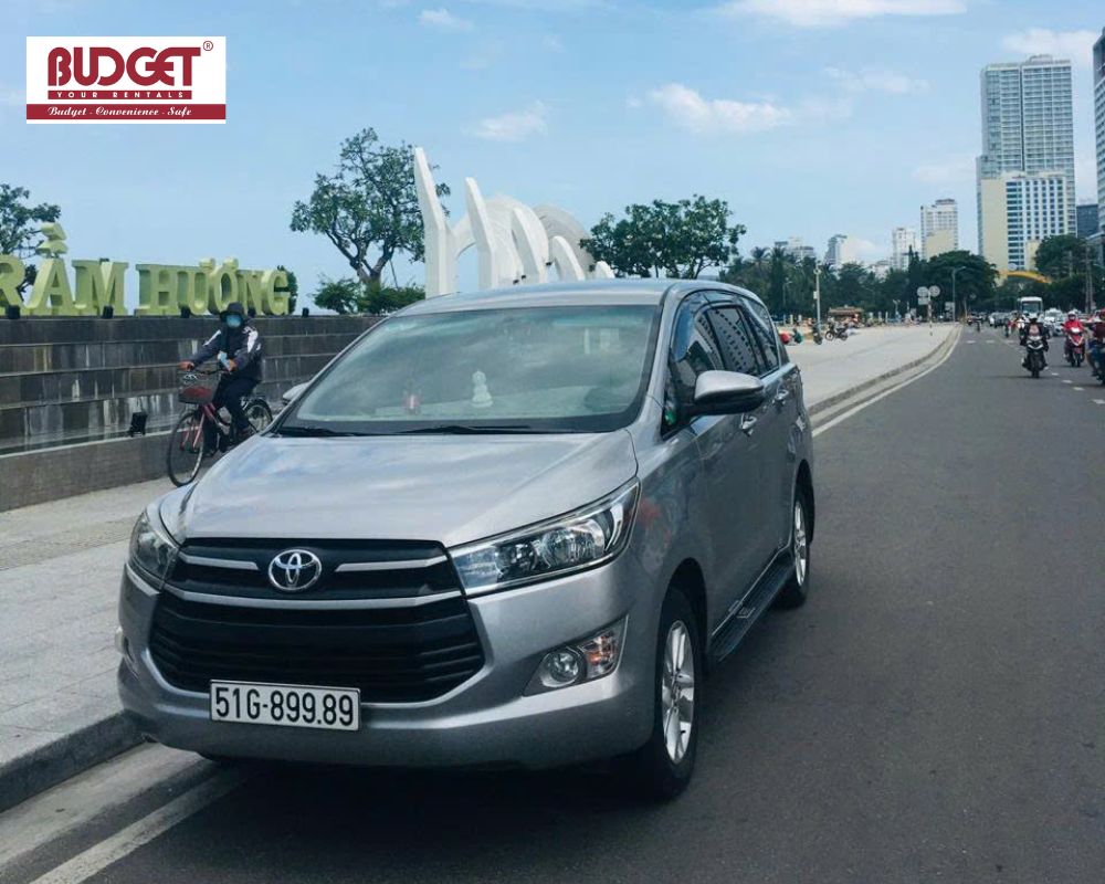 Our-silver-Toyota-Innova-car-parked-near-Tram-Huong-Tower