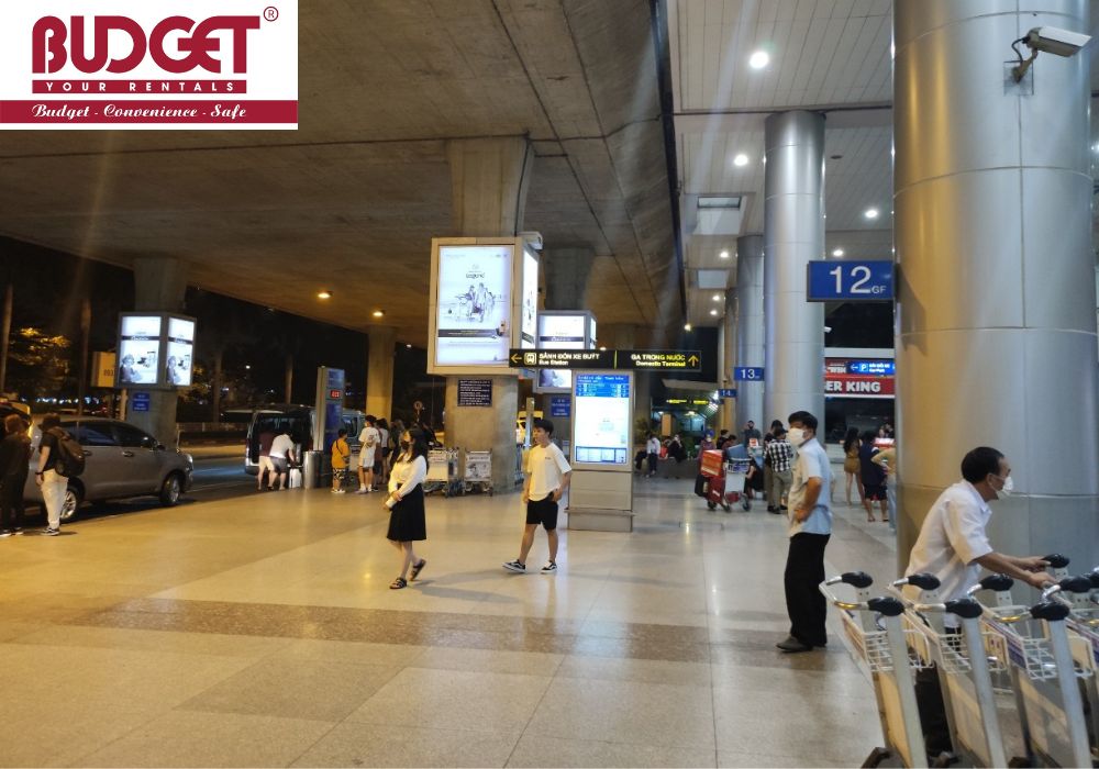 Passengers-waiting-with-luggage-at-terminal-of-Tan-Son-Nhat-International-Airport