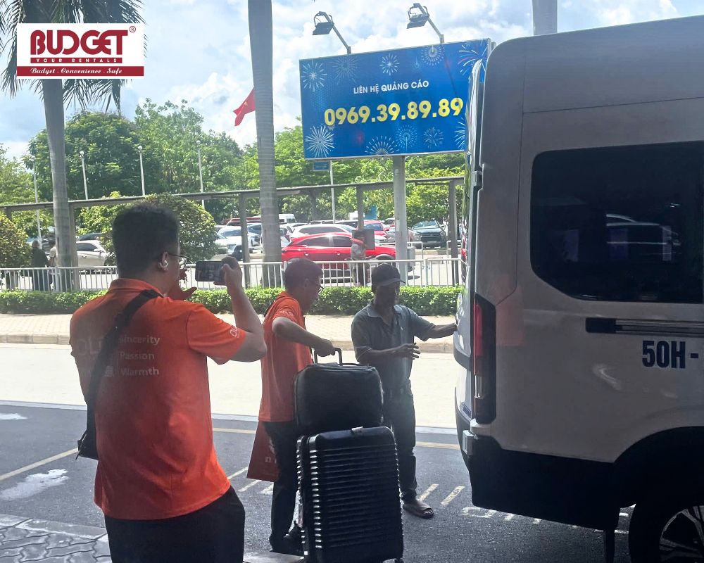 Professional-driver-and-staff-assisting-passengers-with-luggage-at-the-airport-terminal-for-a-private-transfer-service
