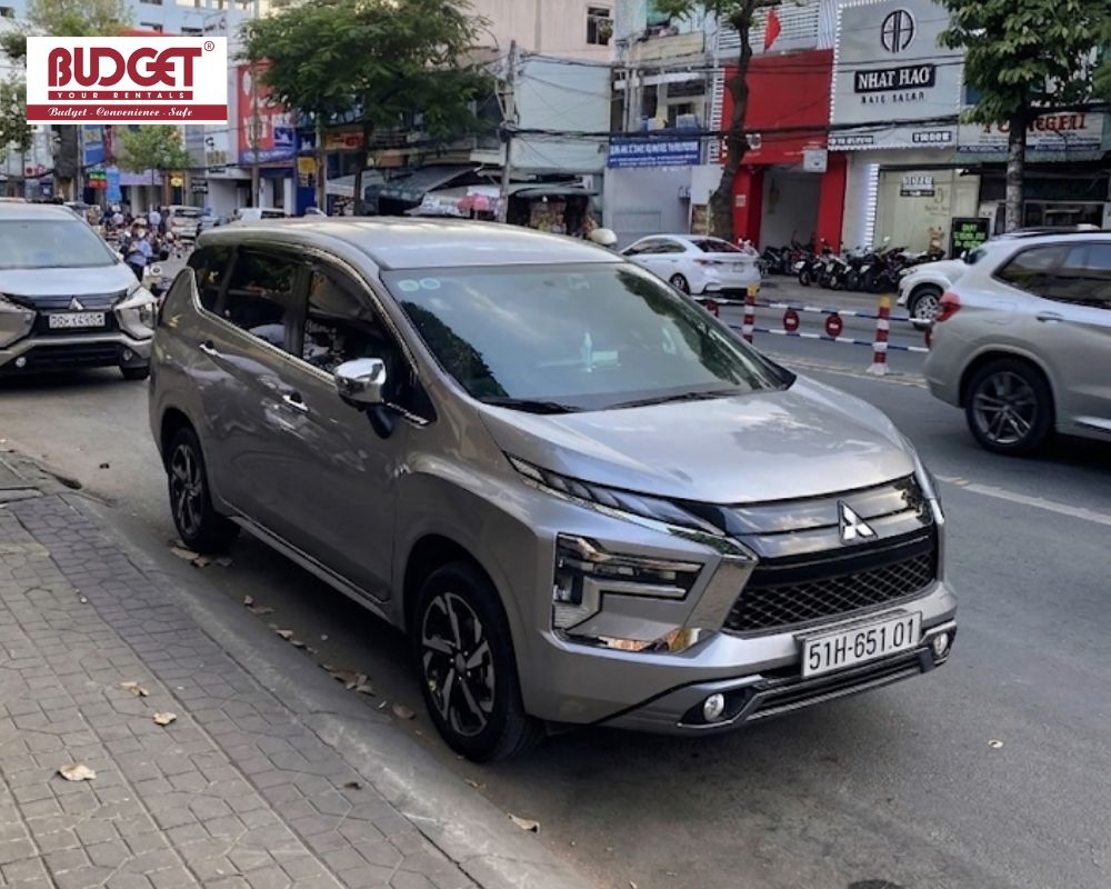 Silver-Mitsubishi-Xpander-paking-on-a-street-in-Ho-Chi-Minh-to-pickup-guests