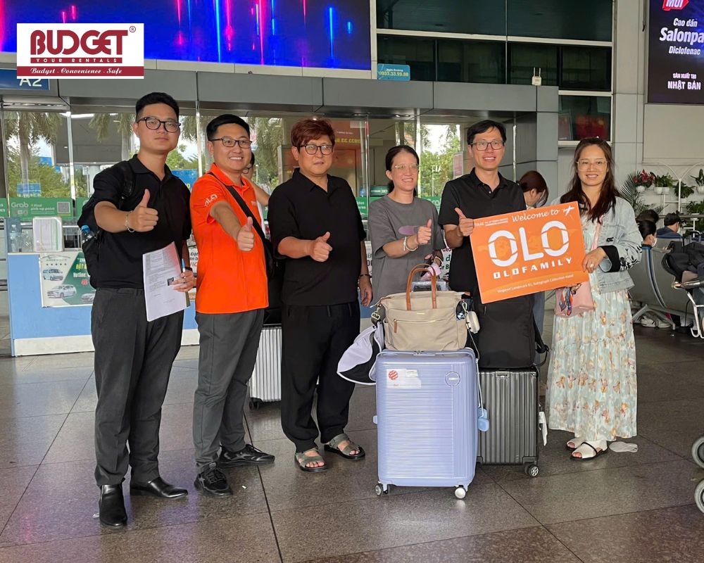 Taiwan-family-holding-a-welcome-sign-at-Tan-Son-Nhat-airport-and-taking-a-picture-with-our-driver