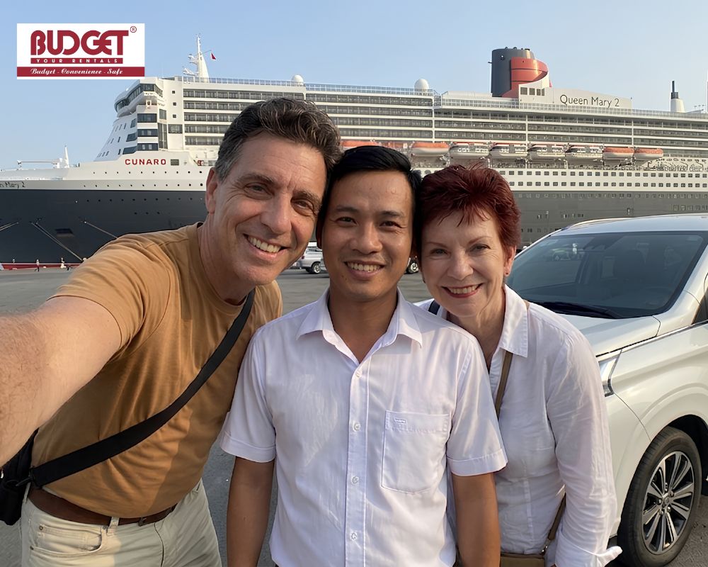 The-couple-taking-a-selfie-with-our-local-private-car-driver-next-to-a-white-SUV-at-Chan-May-Port