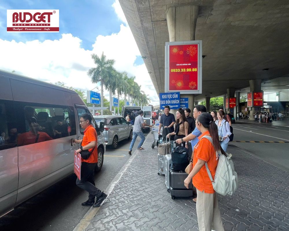 Tourists-with-luggage-being-greeted-by-our-driver-and-tour-guide-at-Tan-Son-Nhat-airport-pickup-point