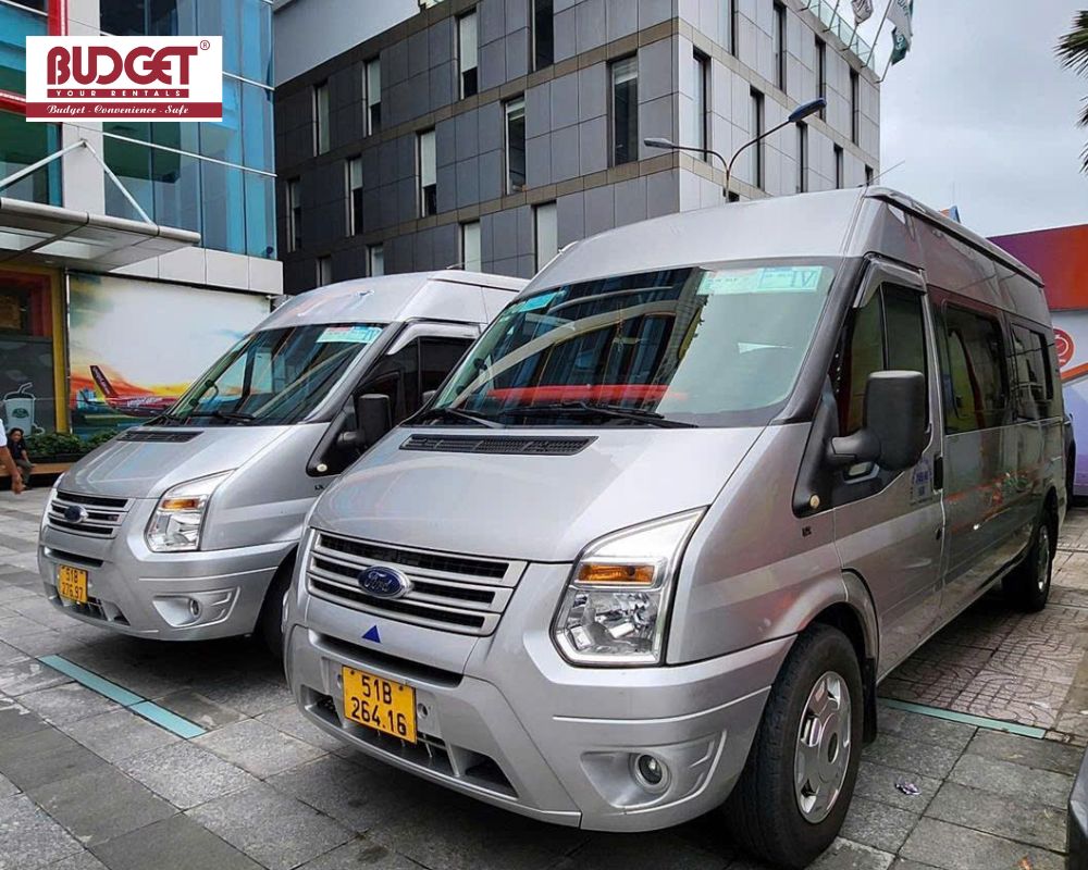Two-Ford-Transit-vans-are-waiting-outside-a-hotel-in-Ho-Chi-Minh-City-to-pick-up-passengers