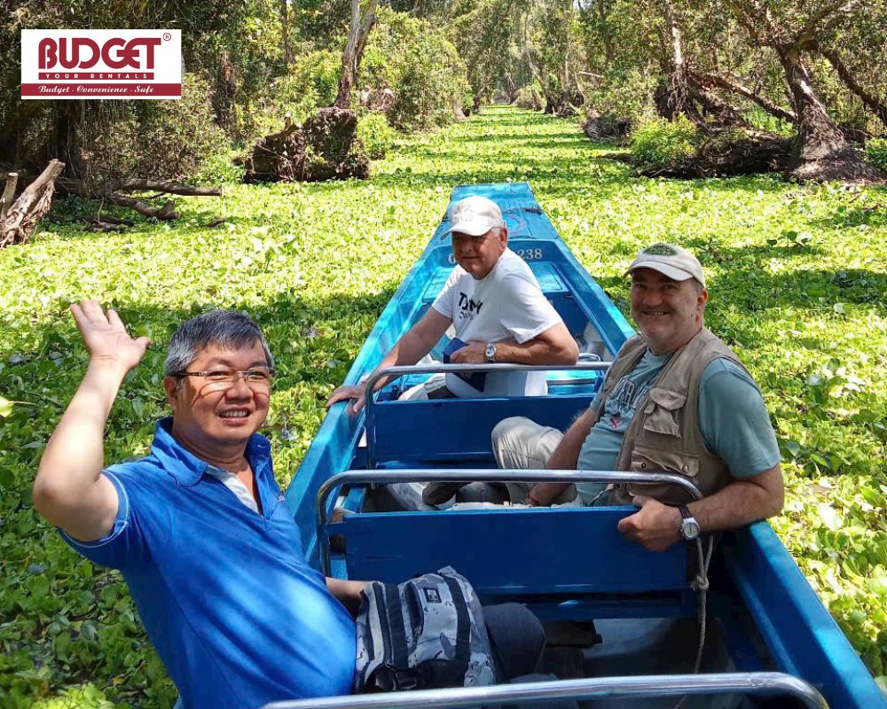 USA-travelers-waving-and-enjoying-a-boat-tour-at-Tra-Su-Cajuput-Forest