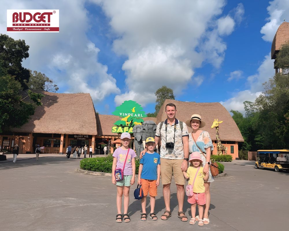 A-British-family-took-a-picture-in-front-of-the-entrance-sign-at-Vinpearl-Safari-Phu-Quoc