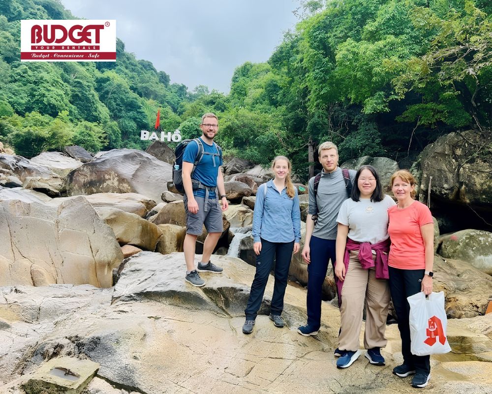A-group-of-international-tourists-took-a-photo-on-the-rocky-terrain-at-Ba-Ho-Waterfall