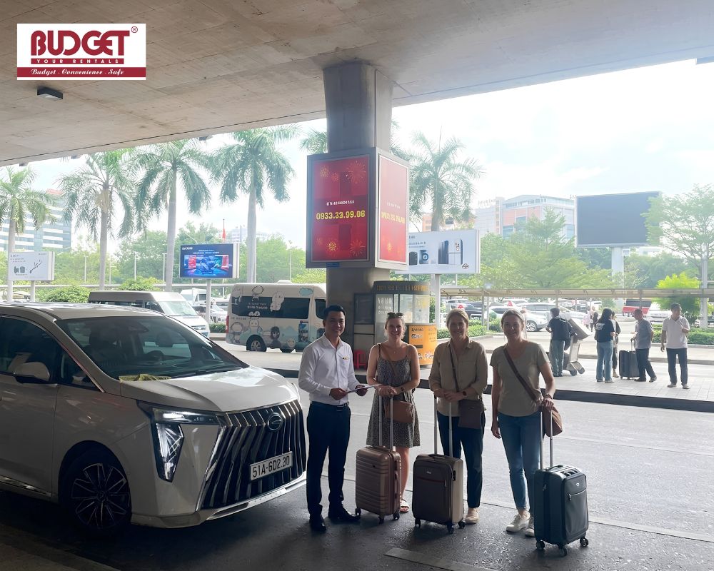 Our-driver-and-American-travelers-took-a-picture-with-their-luggage-next-to-our-car-outside-Tan-Son-Nhat-Airport
